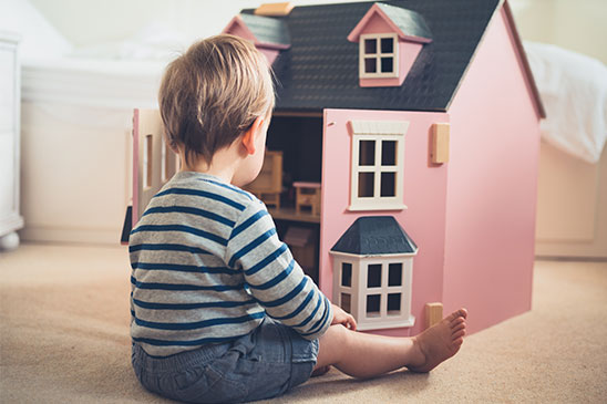 boy playing with doll house