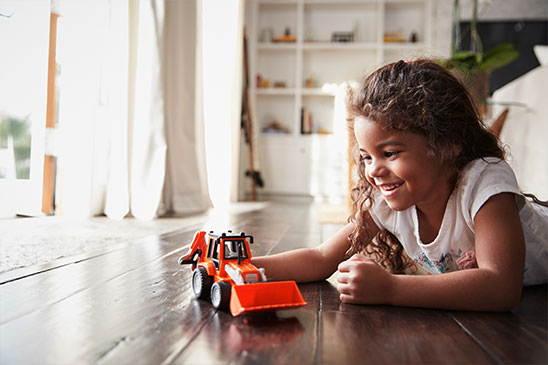 girl playing with truck