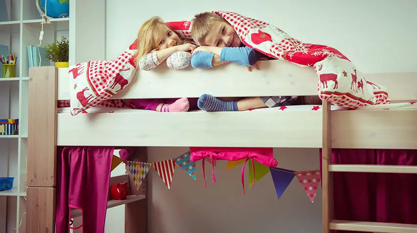 Cute kids playing in a bunk bed