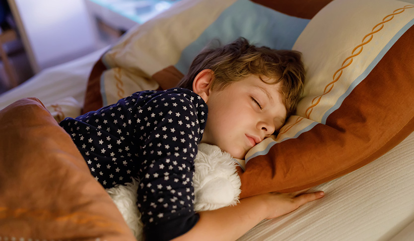 Sleeping child with plush toy