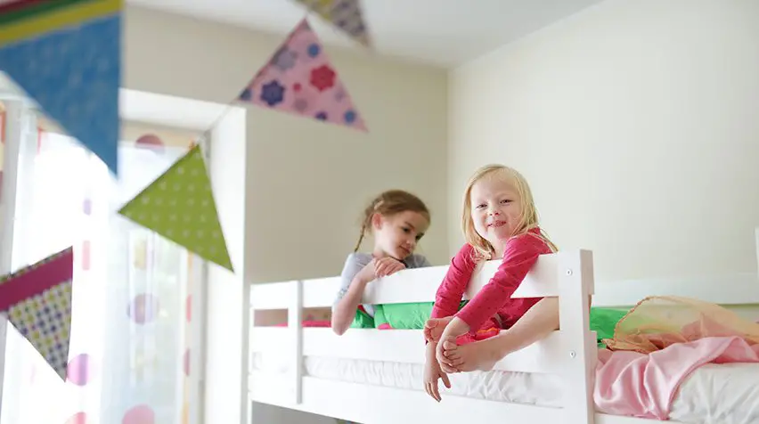 Girls playing in loft bed