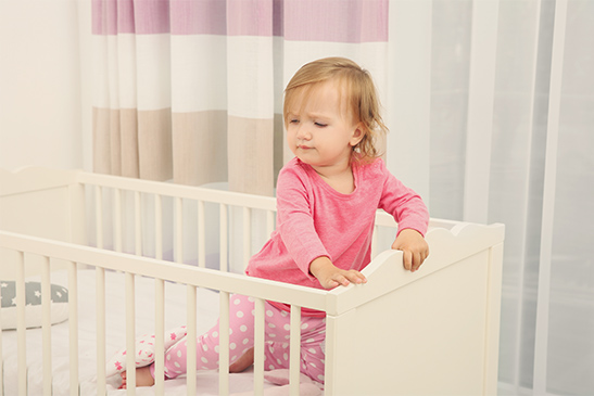 Standing toddler in crib