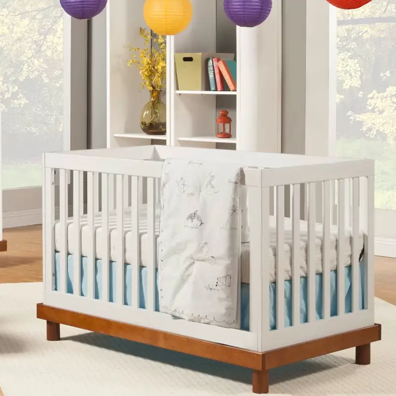 Modern White Convertible Crib With a Natural Wood Finish