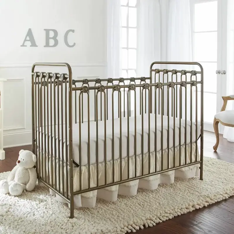 Antique Convertible Crib With a Metal Frame