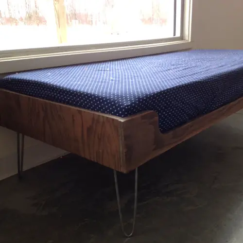 Modern mid-century inspired plywood toddler bed with hairpin legs