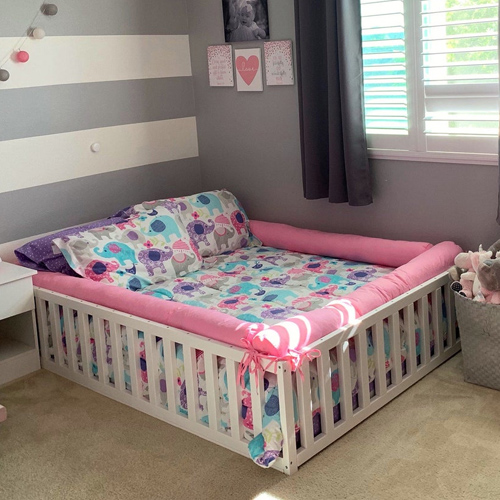 Painted wooden toddler bed with slats