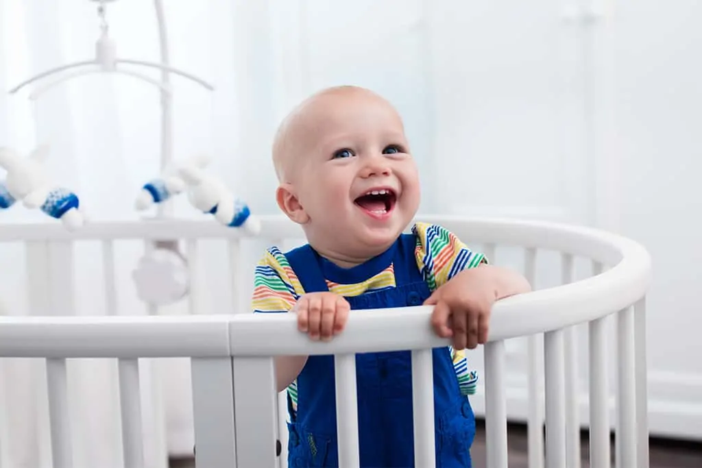 Baby in oval crib