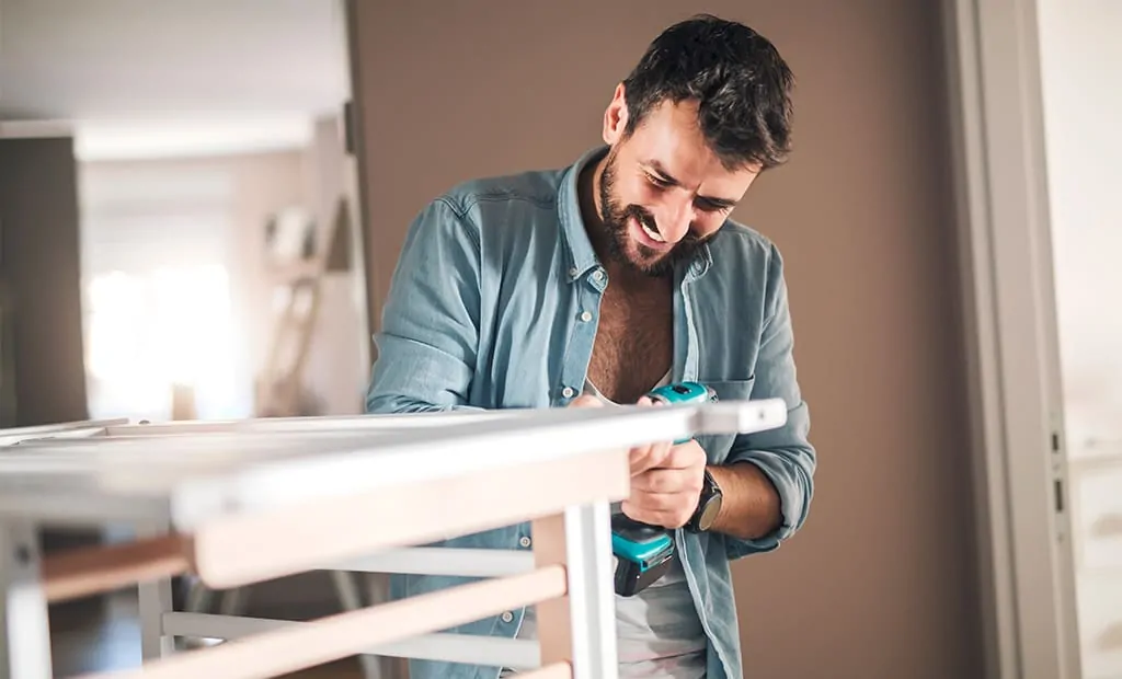 Dad assembling baby crib