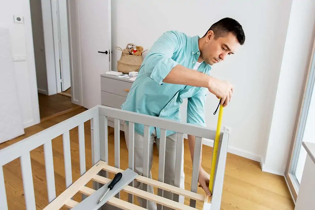 Father converting crib