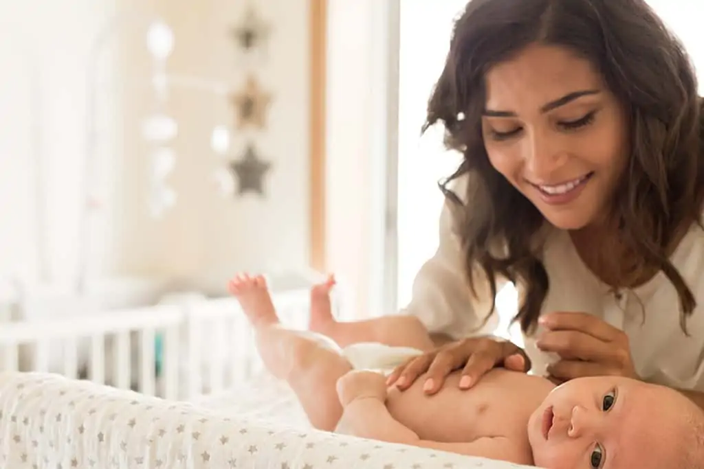 Mother with baby on changing table