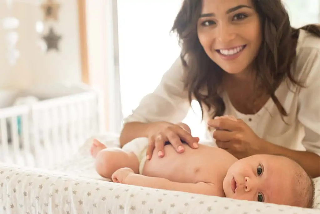 Mother changing baby