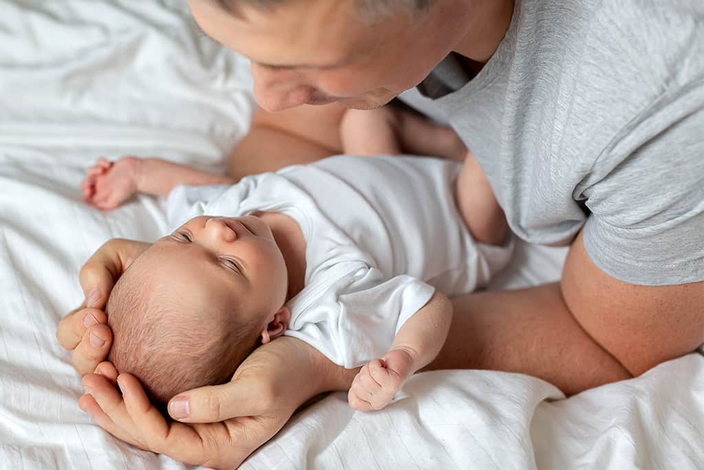 Father putting baby to sleep