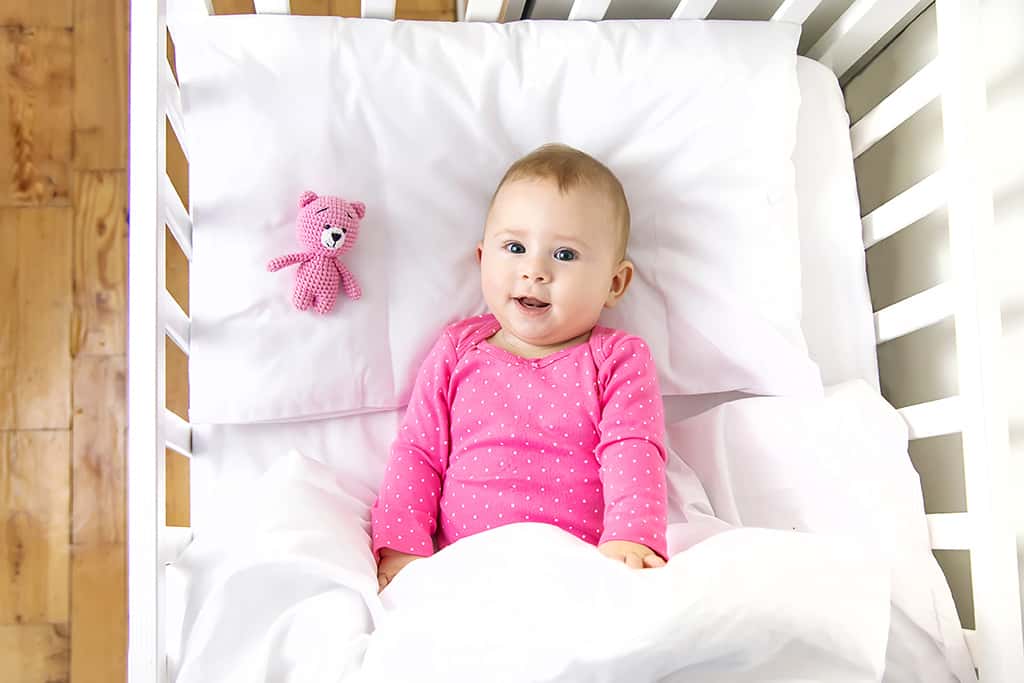 Baby in mini crib